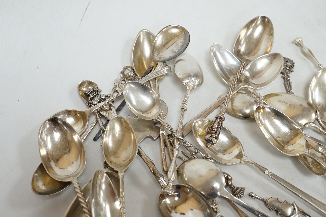 A group of assorted silver and white metal tea and coffee spoons and a pair of silver sugar tongs, weighable hallmarked silver 8.6oz.
